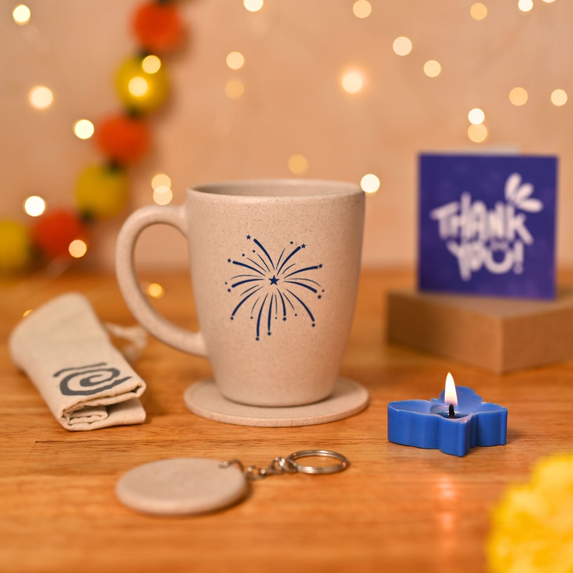 Eha Earth Friendly Diwali Gift Hampers | Cracker Printed Mug, Coaster, Key Chain, Candle, Gift Bag, Card