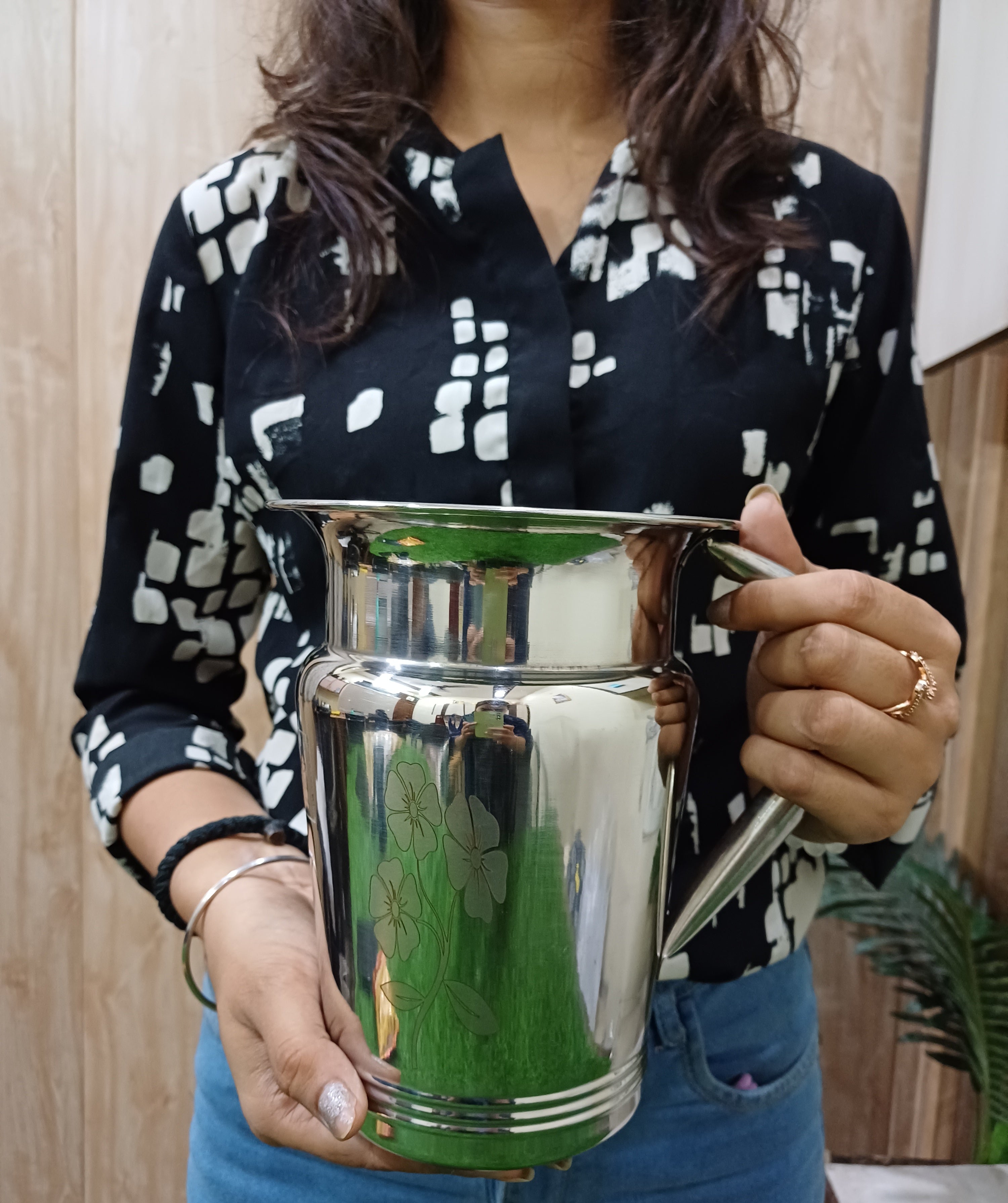 showing  in hand Stainless Steel Floral Lazer Jug 