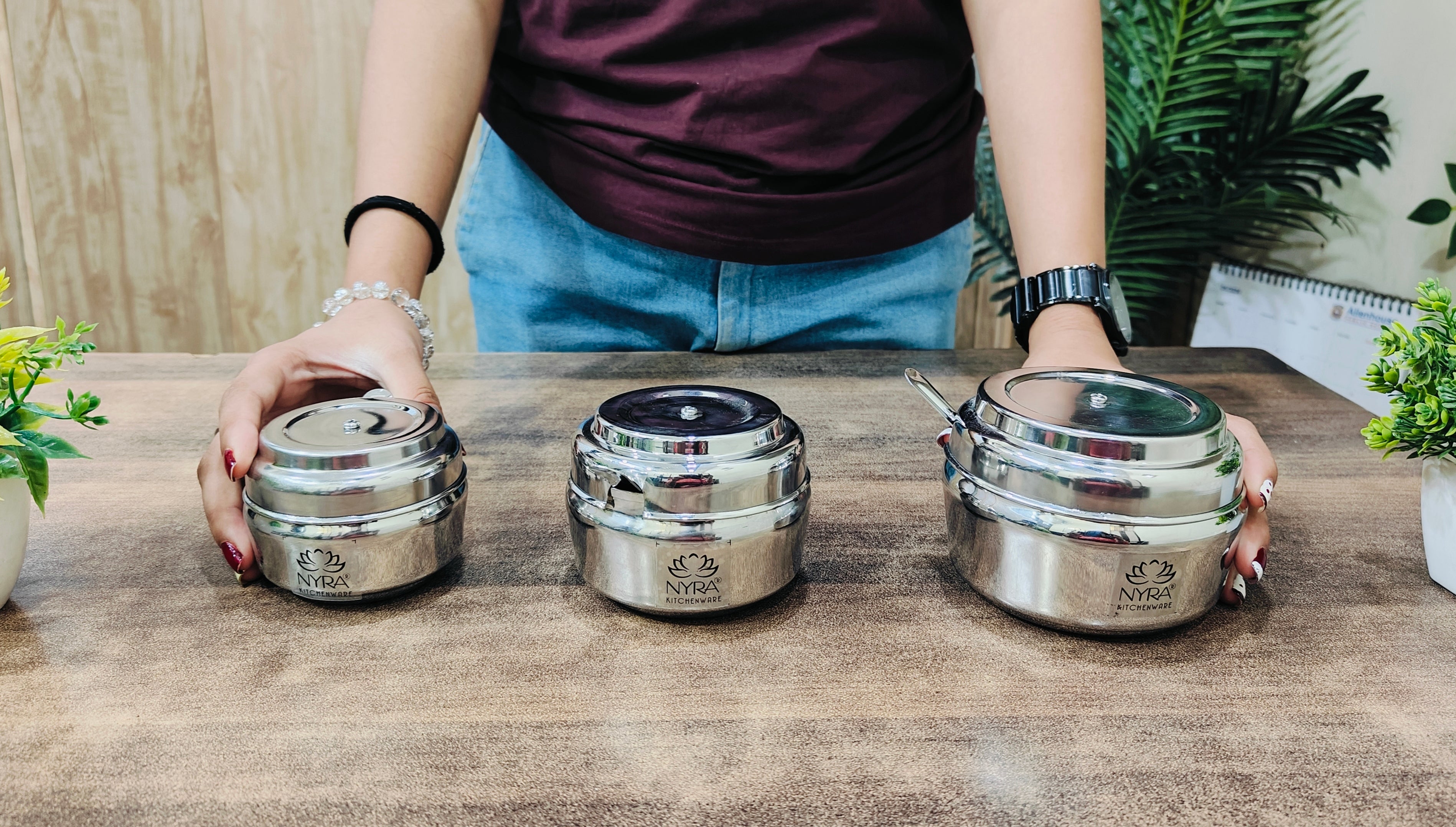 showing in hand Stainless Steel Ghee Pot & Oil Container 
