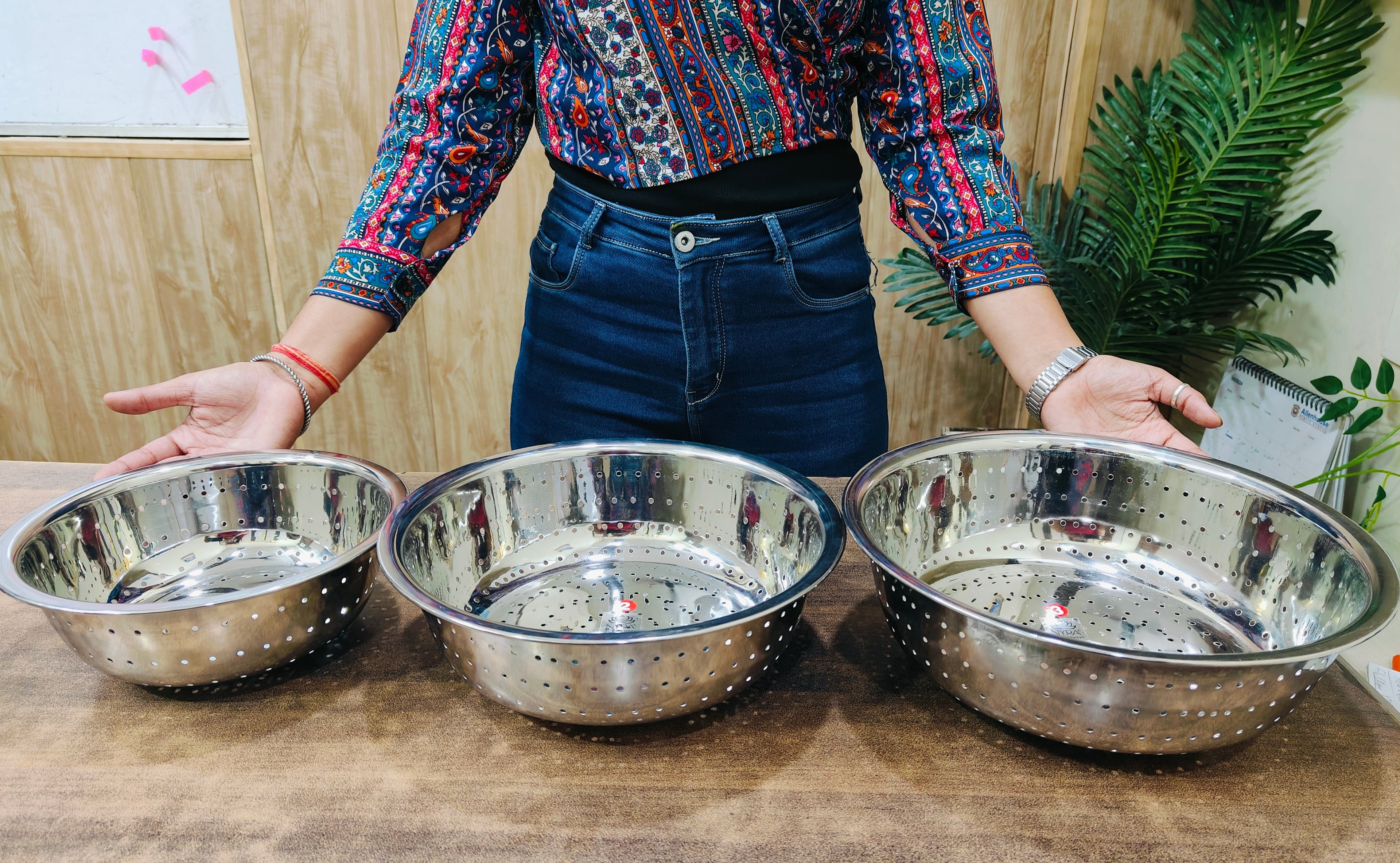 showing in hand different sizes of Stainless Steel Rice, Fruits & Vegetables Basin Strainer