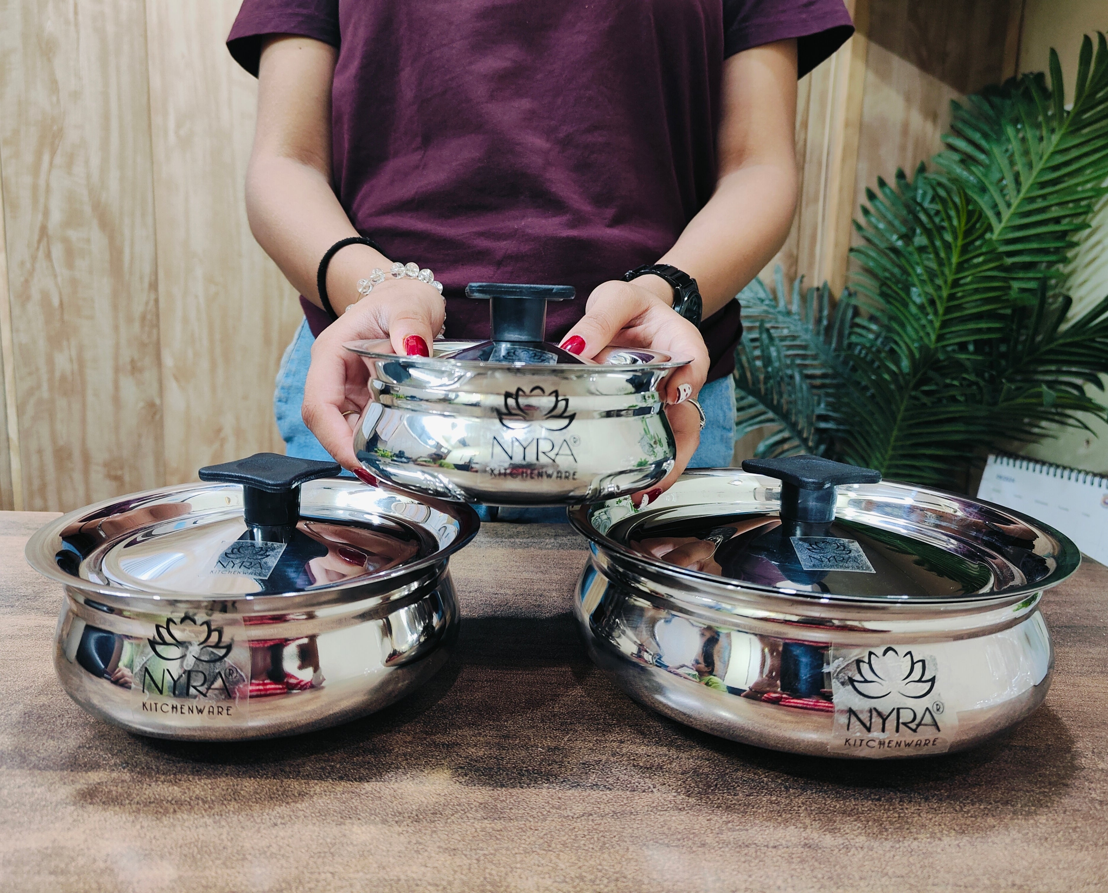 showing in hand Stainless Steel Biryani Handi with Lid and PVC Knob 